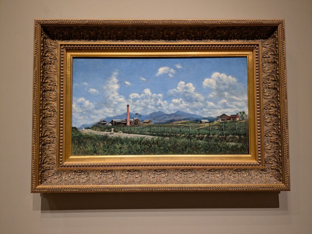 Text from accompanying label:

Oller, the most influential Puerto Rican artist of the 19th century, revolutionized painting on the island with his distinctive modernist vision and dedication to accessible art education. He studied painting in Madrid, befriended Paul Cézanne and Camille Pissarro in Paris, and exhibited his work internationally, but always returned home to San Juan. Born to a white, upper-middle-class family with liberal politics, Oller pondered and captured the many aspects of Puerto Rican life. His paintings include portraits of intellectuals, interiors bustling with diverse communities, still lifes of native fruits, and landscapes glowing with Caribbean light.

Hacienda Aurora is part of a long tradition of Caribbean plantation "portraits." Harmonizing industry with landscape, these images typically minimized the violence of slavery and environmental destruction. Here, Oller pictures a defunct sugar processing plant-its windows darkened, fields uncultivated, and towering smokestack tinged with rust against the blue sky. In 1898, Oller was intimately aware of the decline of the island's once-powerful colonial economy. He likely completed this painting while seeking refuge at the Hacienda Aurora when the United States invaded Puerto Rico during the Spanish-American War.