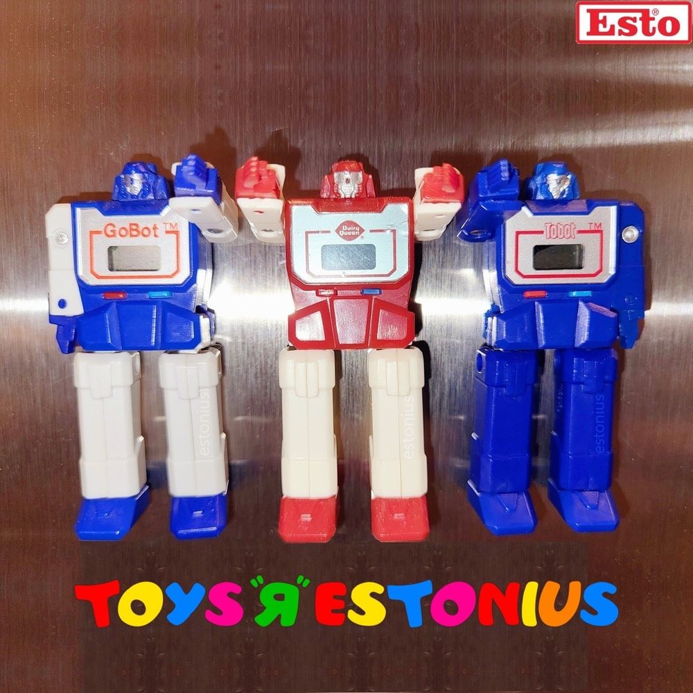 "Inspired" by Takara's super cool Micro Change MC-06 Watch Robo / Diaclone Kronoform 1983 designs, watchmaker Impulse Ltd., under license from Tonka, created an awesome GoBots' version of the robot watch concept released as "Gong" by Tonka in 1984.

Impulse Ltd. also released it themselves as "Tobot" in that same year.

That same design was then further licensed to CMI Corporation's Sweda, who produced it as a promotional item for Dairy Queen, replacing GoBot's logo with Dairy Queen's logo and using Dairy Queen's logo colours as its colour scheme in 1985.

Besides the very cool design, they also have magnets on their backs! [Fridge Magnet Status!]