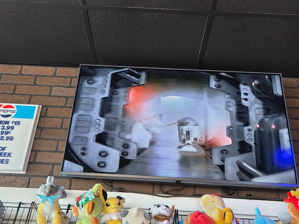 An image showing Leia putting her message to Obi-Wan into R2D2 during the beginning portion of Star Wars Episode IV: A New Hope 