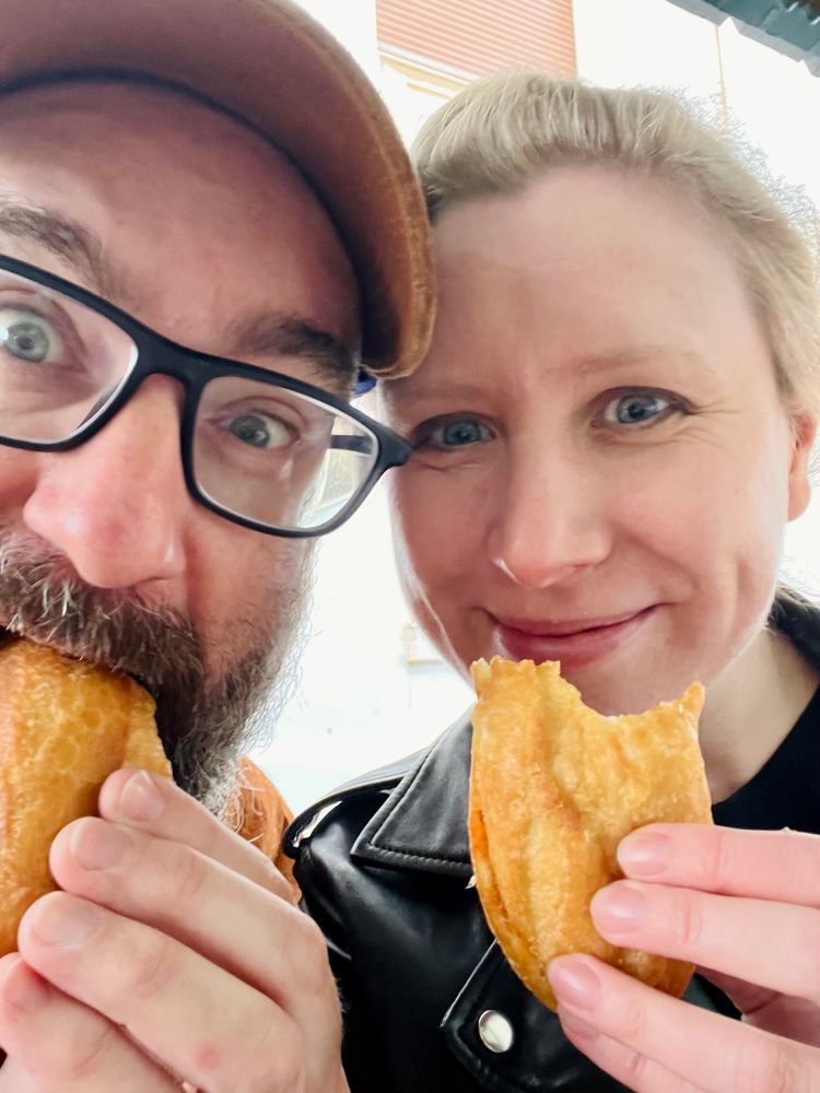 Hannah and Matt are enjoying Fricasse - a puffy roll filled with spicy egg, tuna and salad 