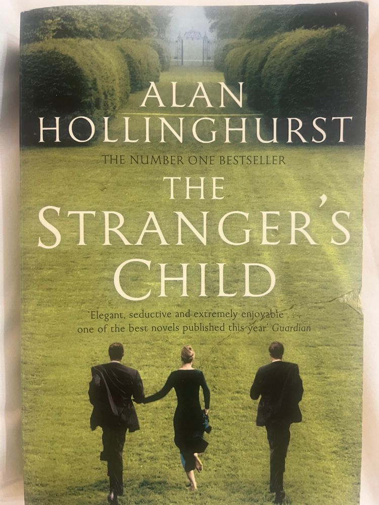 Book cover of two men in suits with a barefoot woman in an evening dress between them. They appear to be running across a broad hedge-sheltered lawn to imposing wrought-iron gates in the distance. 