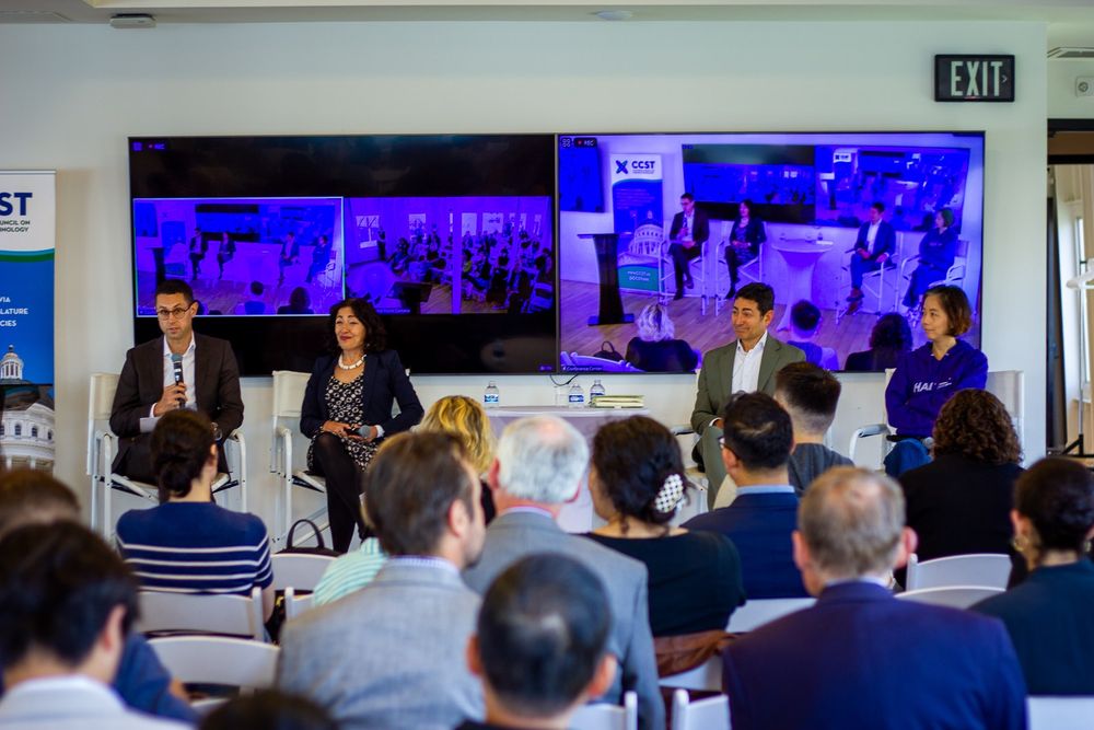 Photo of panel from back of the seated crowd