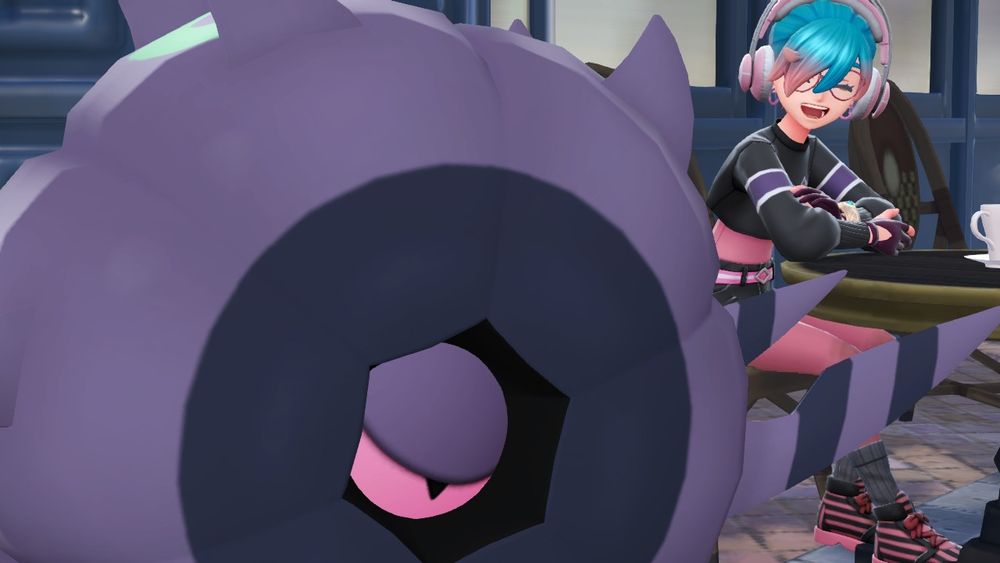 A screenshot of N's PLZA player character and a shiny Whirlipede at a cafe.