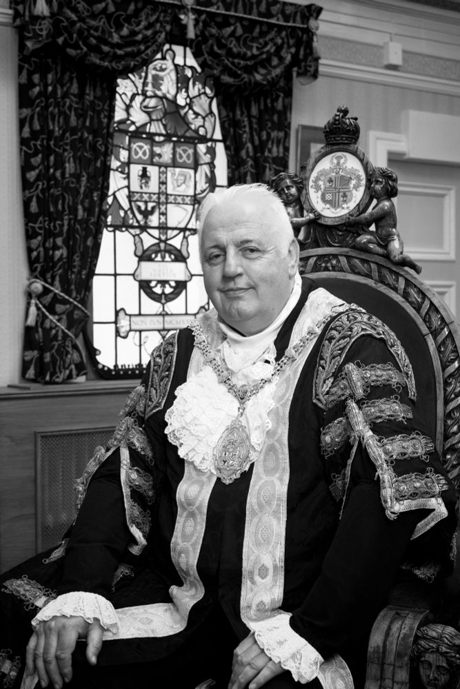 Portrait photograph of Stoke-on-Trent Lord Mayor, black and white, wearing ceremonial robes, seated in Lord Mayor’s parlour
