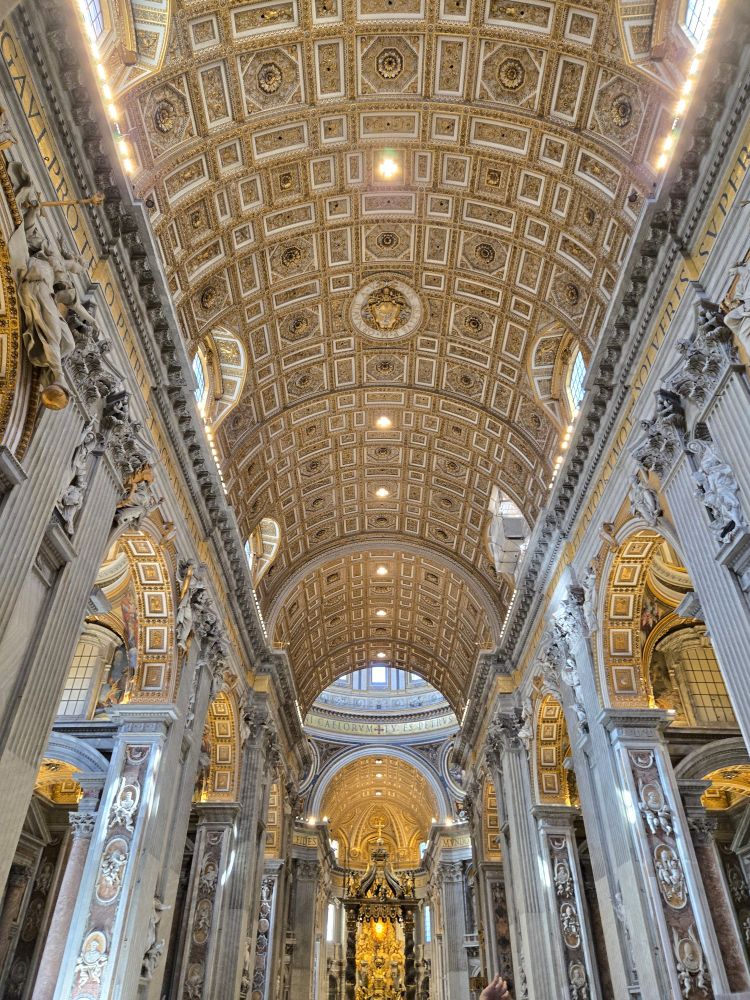 photo of the inside of st. peter's basilica in vatican city, focusing on the main corridor and ceiling 