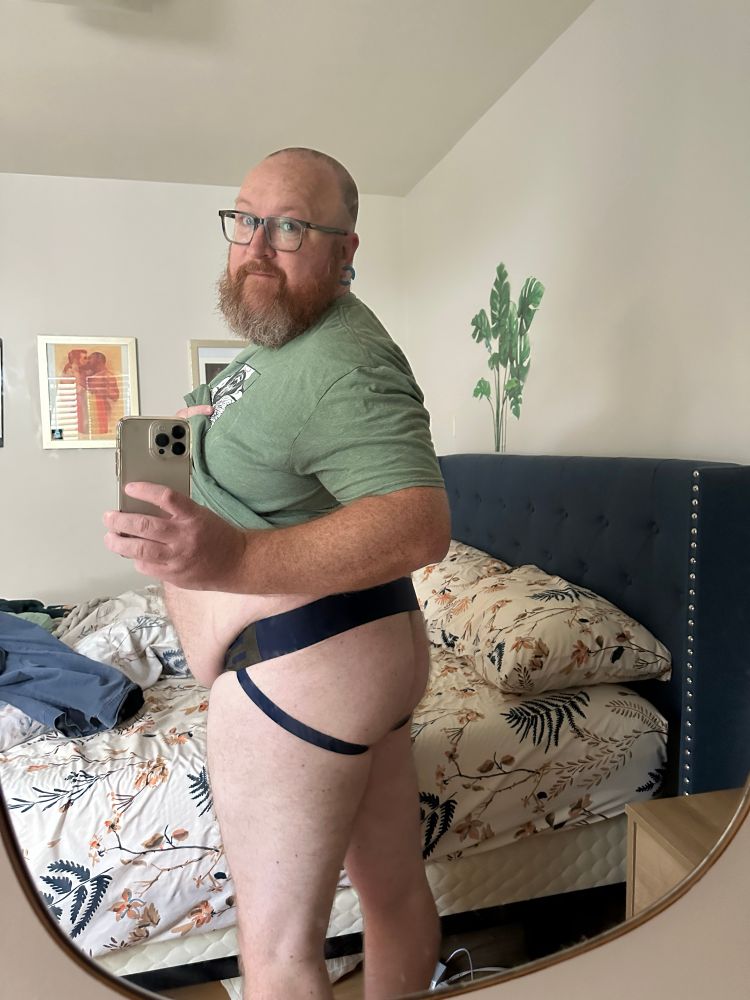 Turned a bit over the shoulder so you get a glimpse of both ass cheeks in the jockstrap
