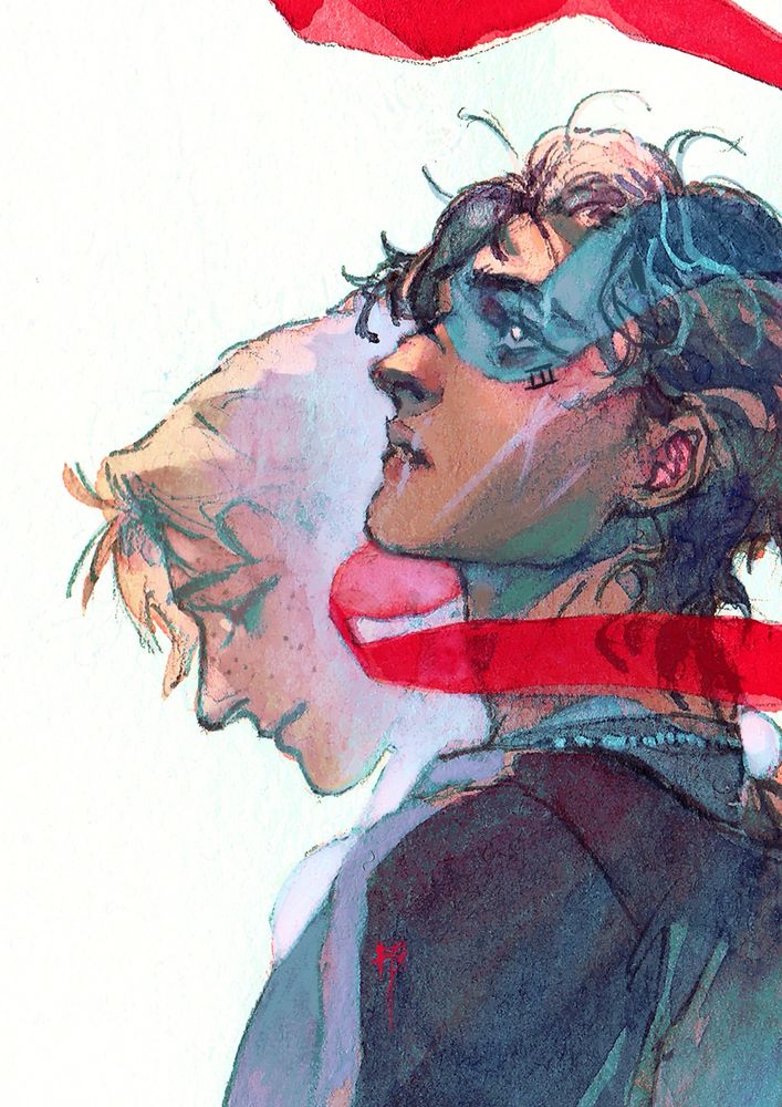 a boy with a red ribbon looped around his neck like a scarf looks up; there is a person behind him