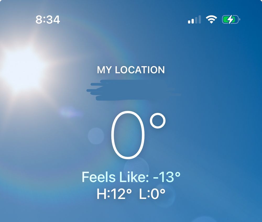 Screenshot of current temp. 0 degrees at my location, feels like 13 below