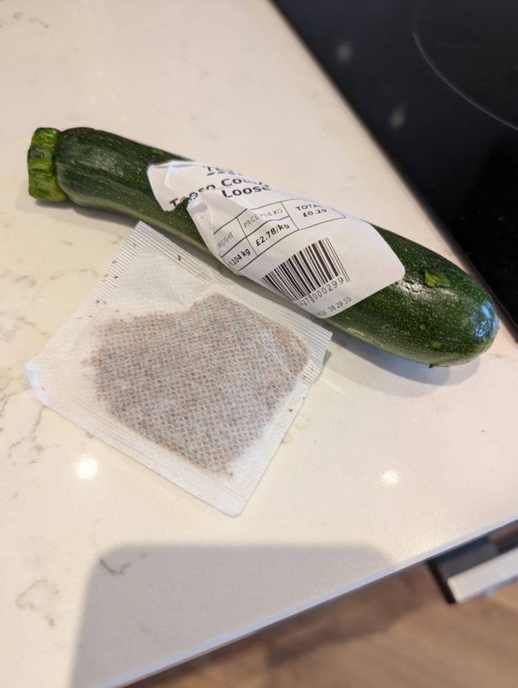 A very small courgette barely bigger than a teabag.