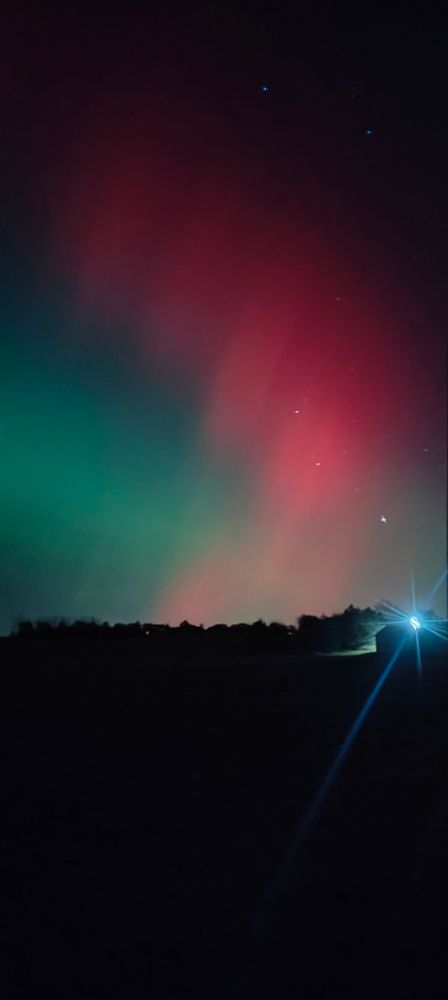 Red and green aurora borealis in the sky 