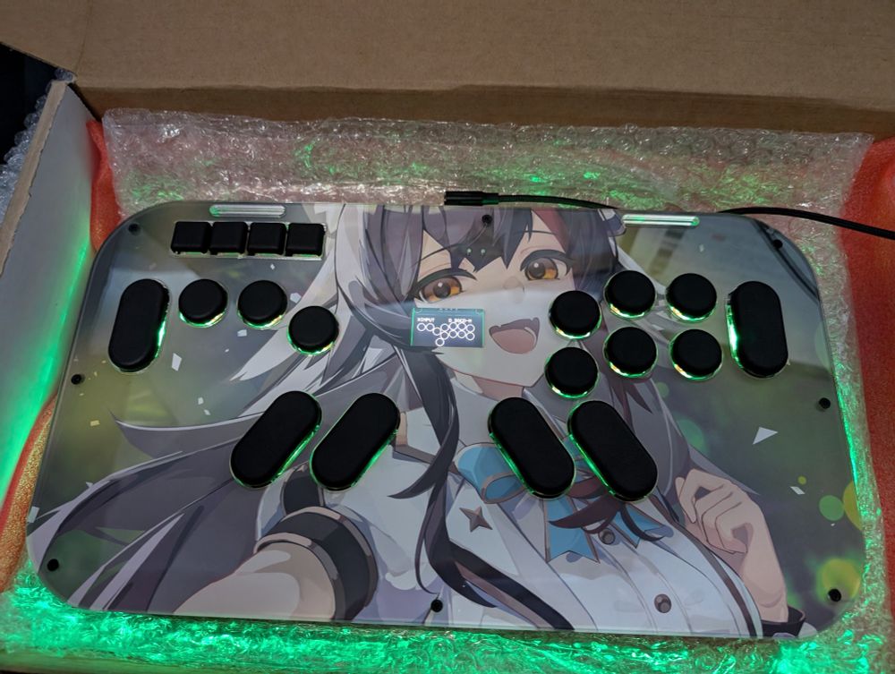 A picture of a leverless controller, made by mavercade. The artwork on it is the virtual YouTuber Ookami Mio of Hololive GAMERS.