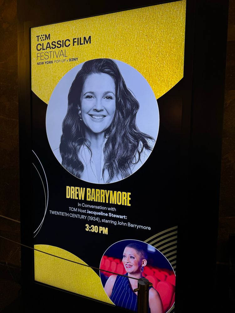 Event poster for TCM Classic Film Festival featuring Drew Barrymore and host Jacqueline Stewart. 
