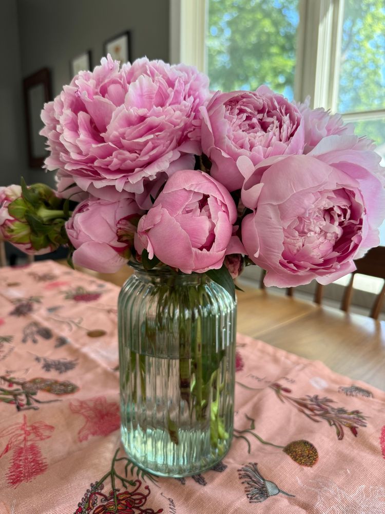 pink peonies in a green glass vase