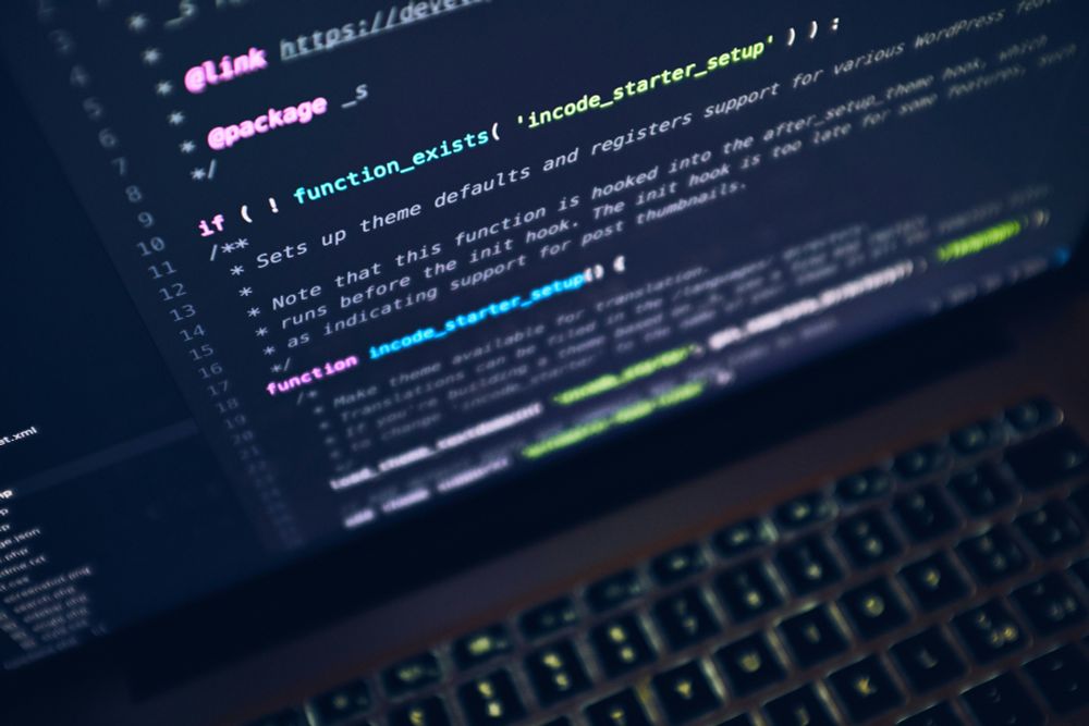 Photo of a computer with code on the screen