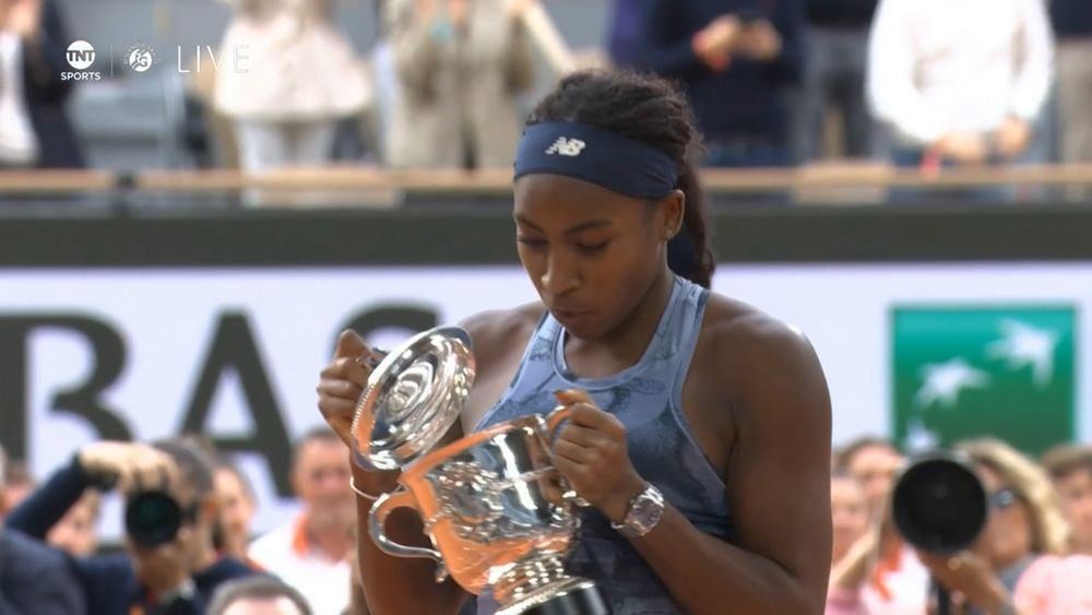 Coco Gauff checking if there's anything inside the Roland Garros trophy
