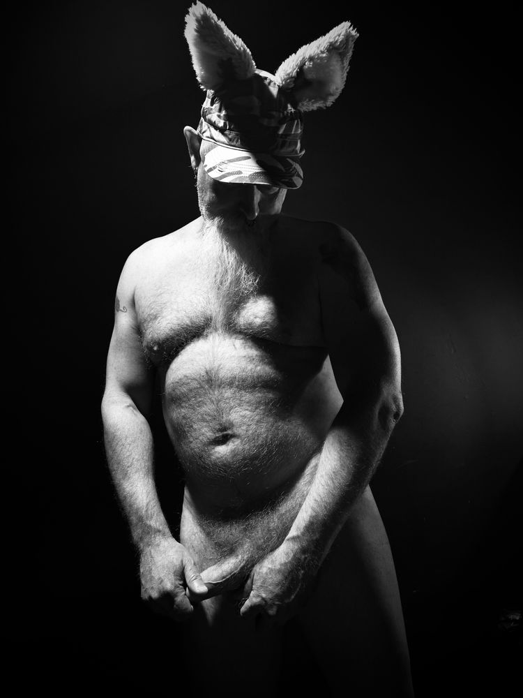 nude for older male wearing an ear hat. Black and white 
