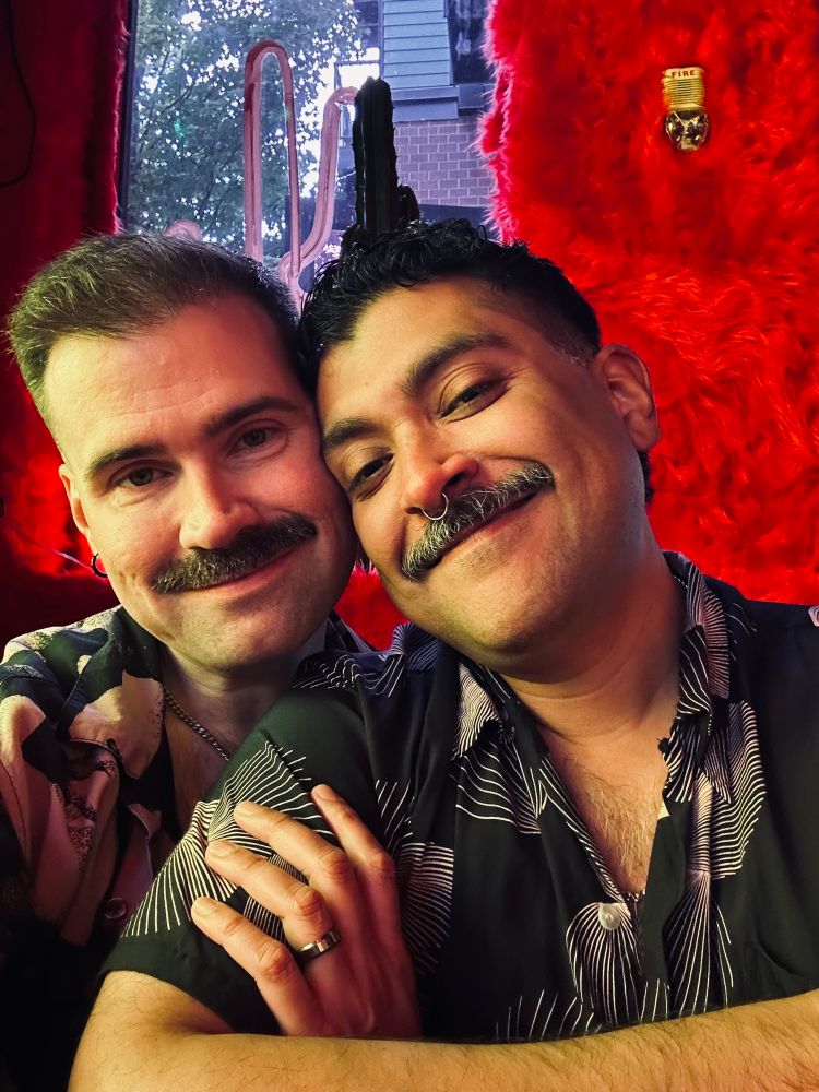 a photo of me and my husband looking at the camera and smiling. 