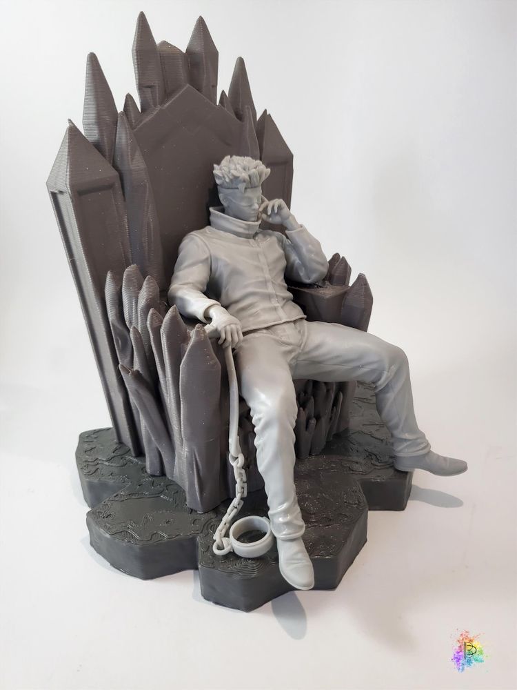 A test-print of the same figure, in grey resin and dark grey PLA.