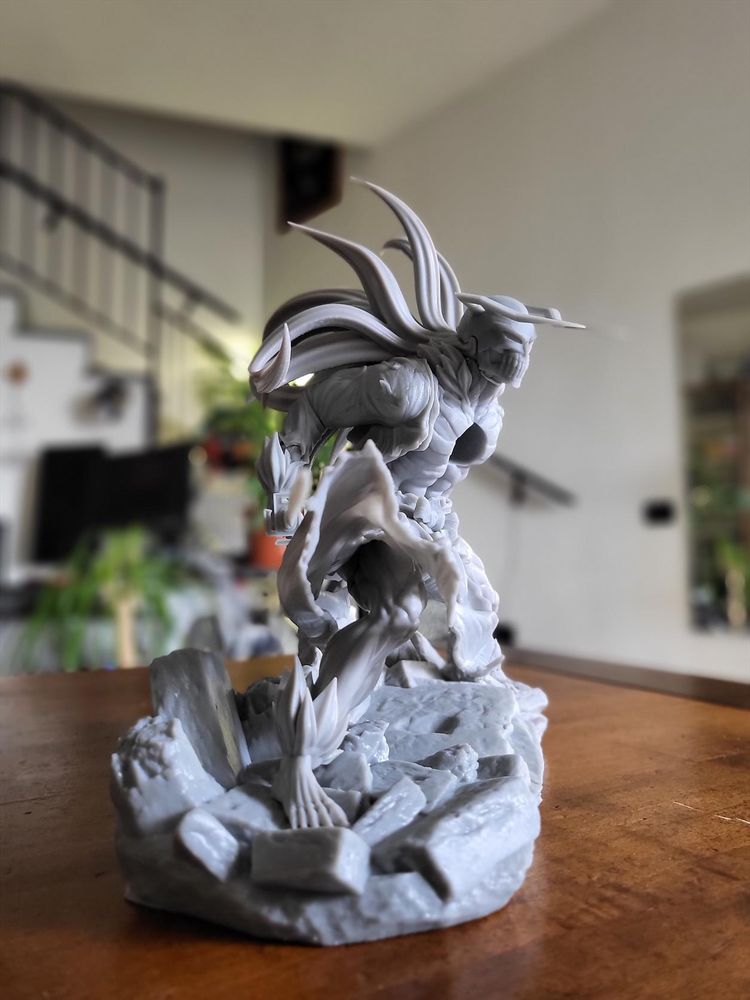 The same printed figure, from a different angle that highlights the muscles of the right leg.