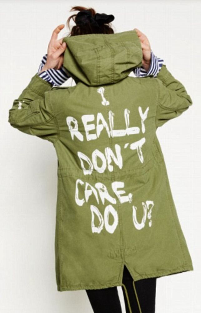 Melanias green coat that says "I really dont care, Do u?