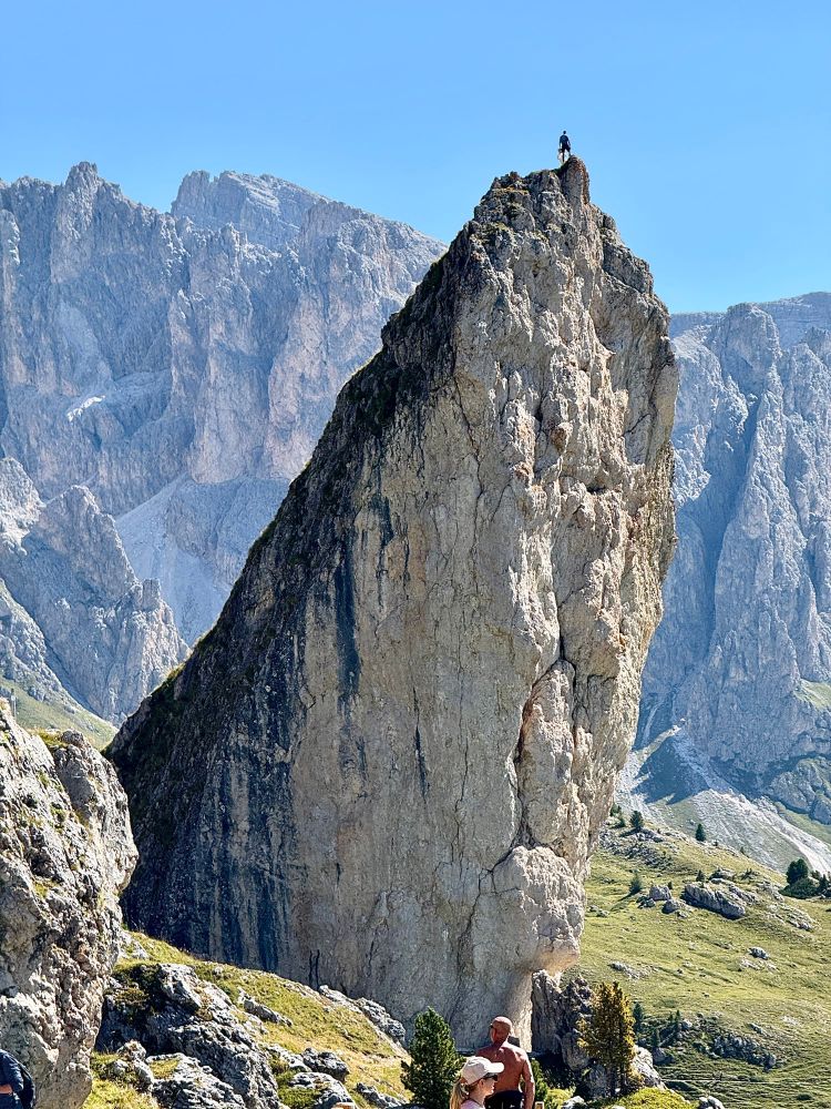 Nope! A man standing on the top of a very steep rock. 
