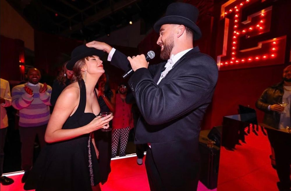 Travis gave Taylor 22 hat at the eras themed party.