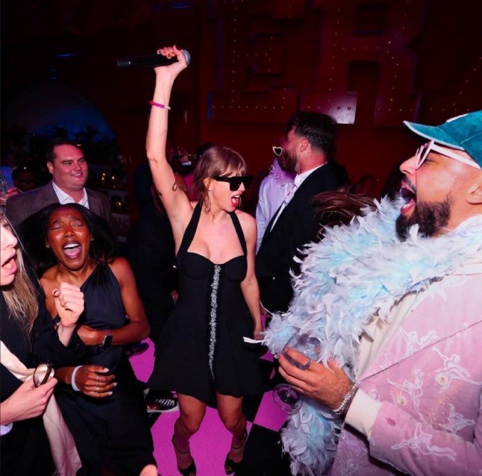 Taylor with friend at the eras themed party.