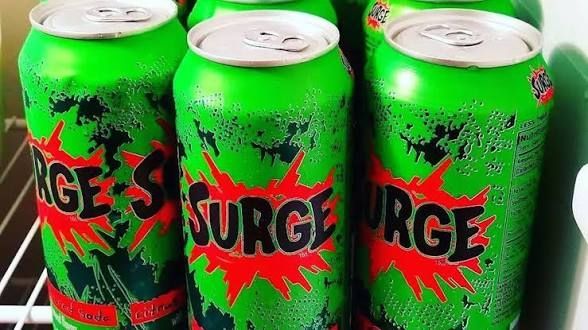 Several cans of Surge cola.