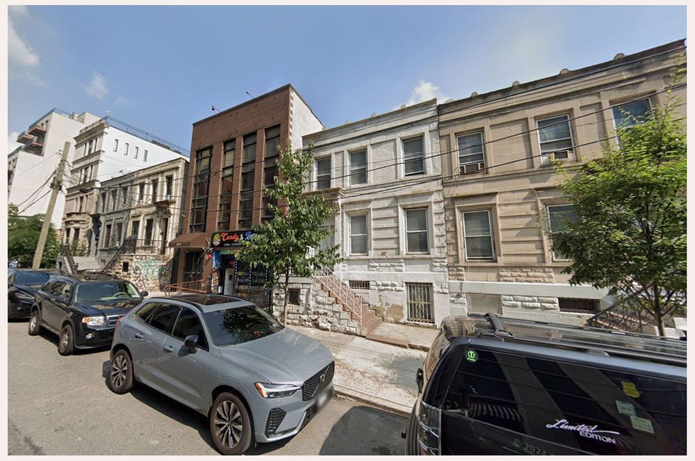 A row of two story flat roof town houses in Long Island City, Queens, in 2024.