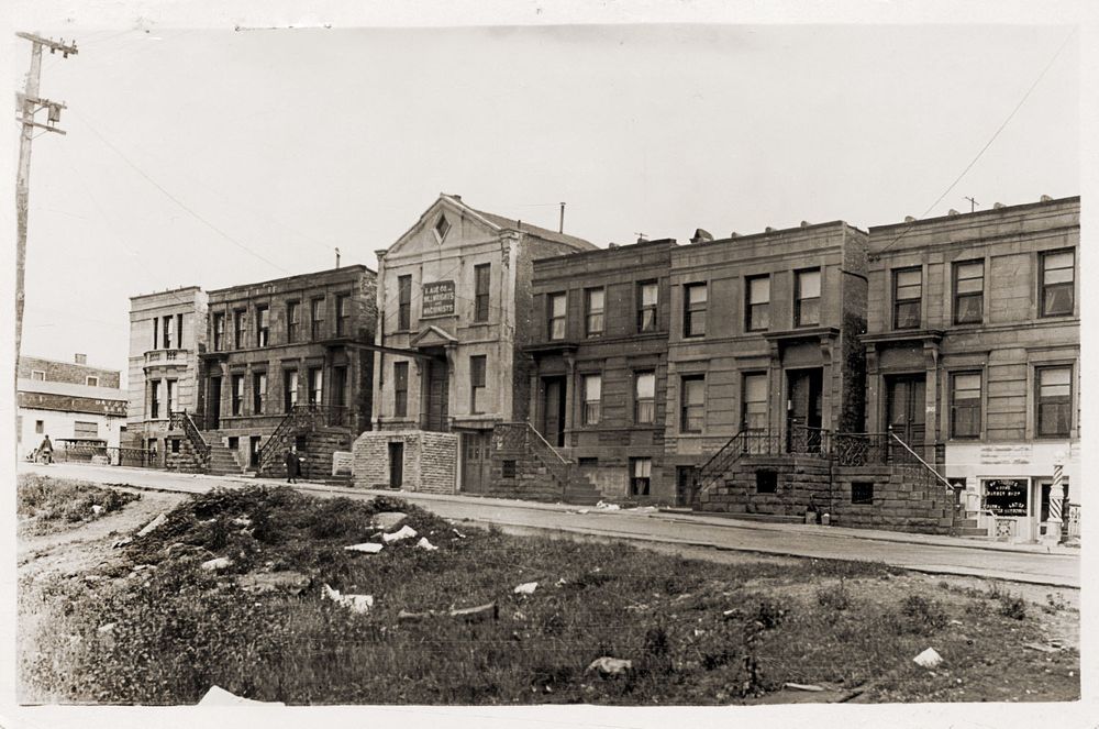 A row of two story flat roof town houses in Long Island City, Queens, in the 1920's.