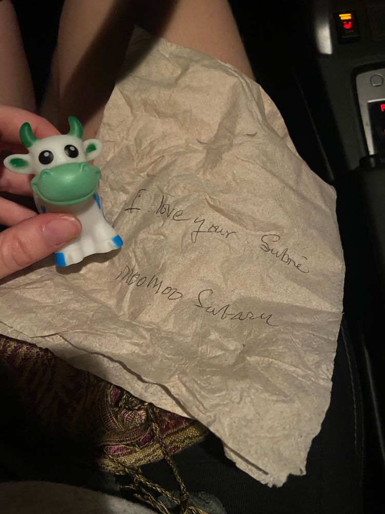 little blue cow toy, note on a napkin that says “i love your Subré. moo moo subaru”
