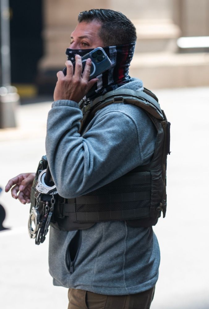 ERO Chicago agent in gray hoodie and black and white American flag gaiter (with red stripe for firefighters)