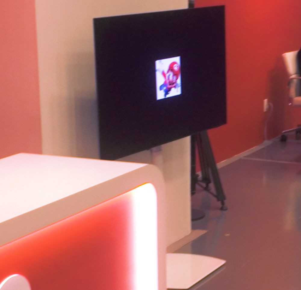 a tiny picture of Mario on a big tv