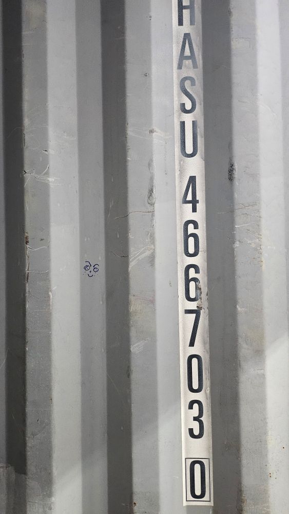 interior wall of a shipping container with a series of letters and numbers