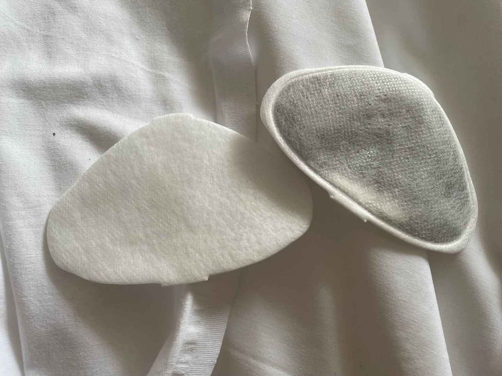 Photograph of two Flo Mask filters, one clean and white, the other a rather dark grey