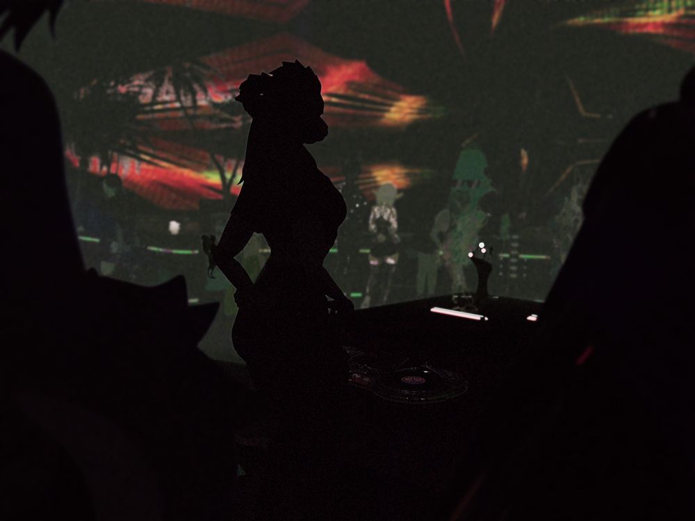 A silhouetted creature is visible at the DJ decks in front of a trippy sky.