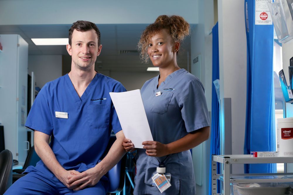Two members of nursing staff looking to camera