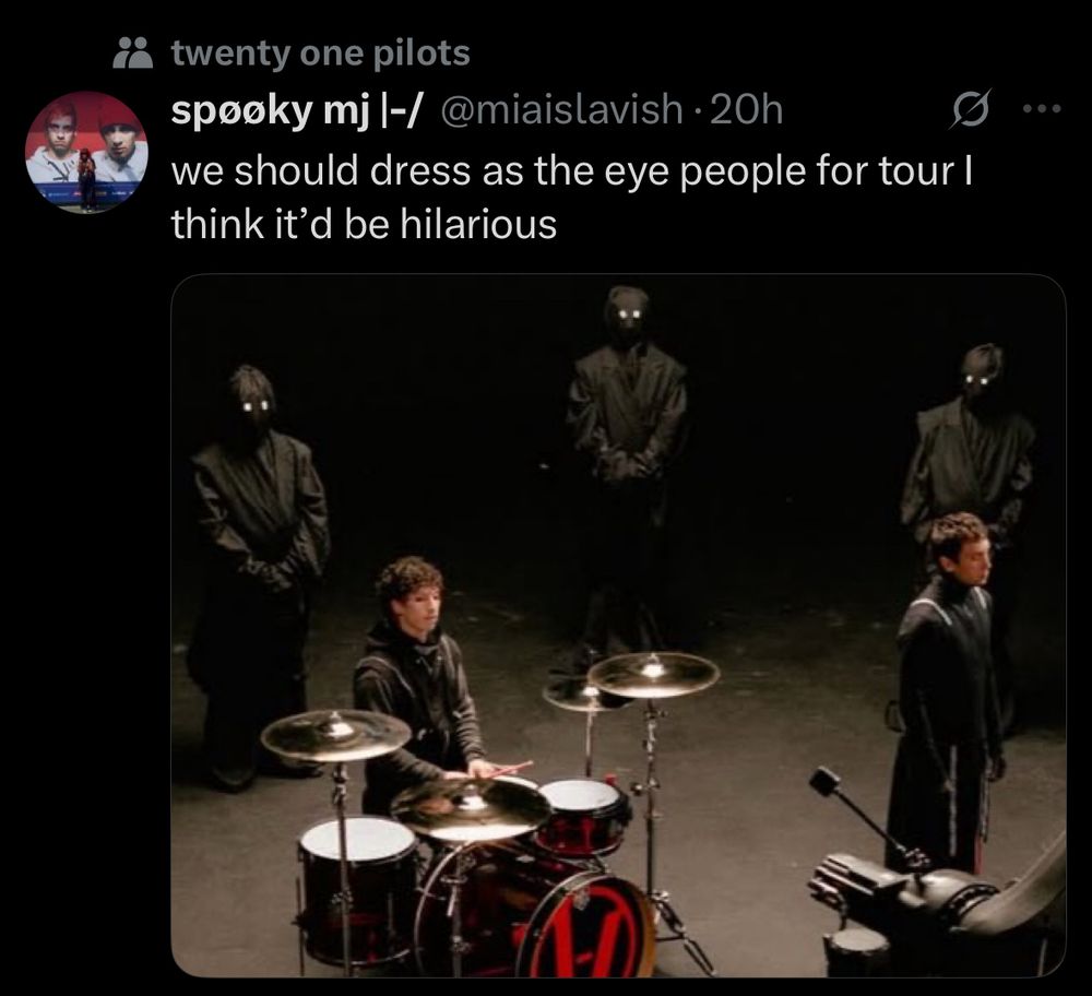 screenshot of a tweet. “we should dress up as the eye people for tour I think it’d be hilarious”. tweet contains an image from the contract music video with creepy people in the background wearing all black with white eyes.