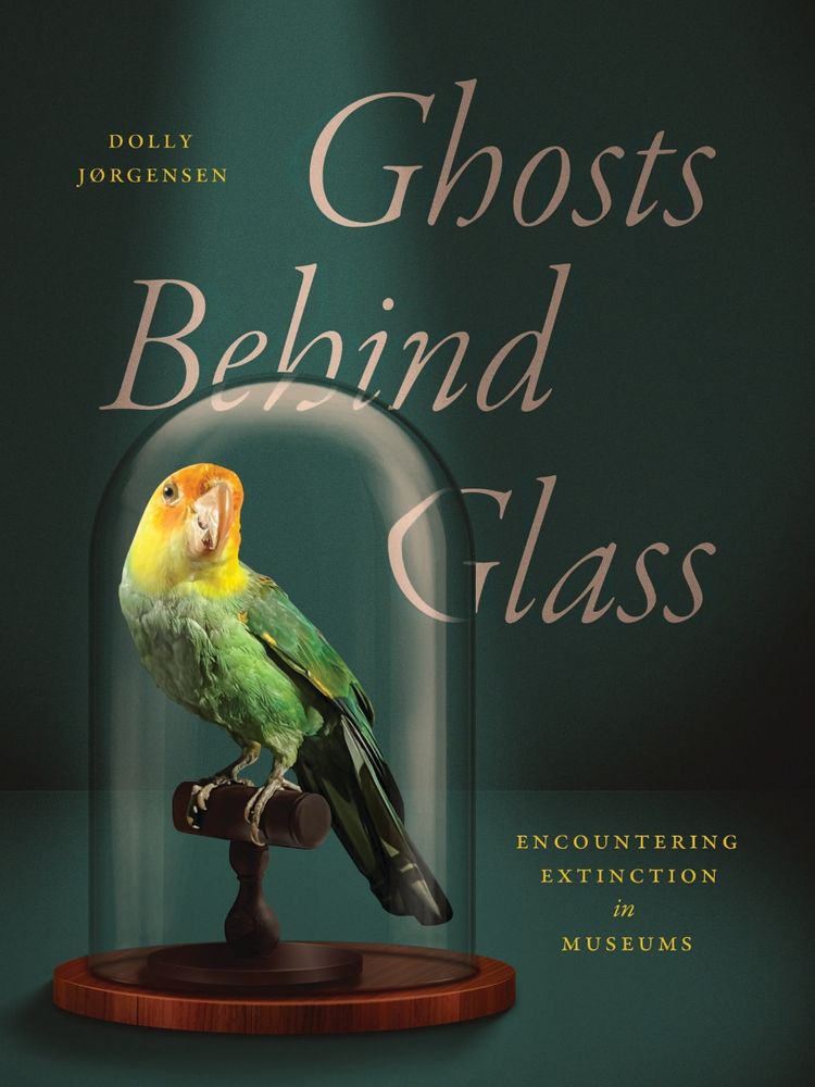 Book cover of Ghosts Behind Glass with colorful Carolina parakeet under bell jar