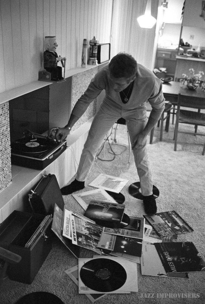 Steve McQueen, Palm Springs, California, May 1963. There are a number of records spread out at his feet on the carpet, from Miles Davis, Sonny Rollins and Frank Sinatra scattered at his feet, 1963. Photo © John Dominis/The LIFE Picture Collection