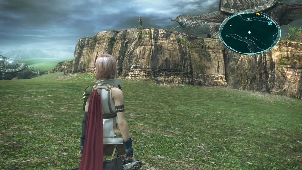 a screenshot from ffxiii, from the sprawling plains of gran pulse. lightning stands on low ground while hope is stranded on high ground, his ai clearly unable to find a way down to where lightning is. if you listen closely you can hear me yelling ITS OKAY BABY BOY I WILL SAVE YOU!!!!!! 