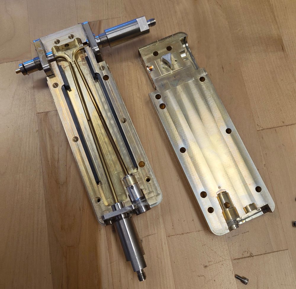 A rectangular aluminium housing with a recess milled for two copper conductors. 