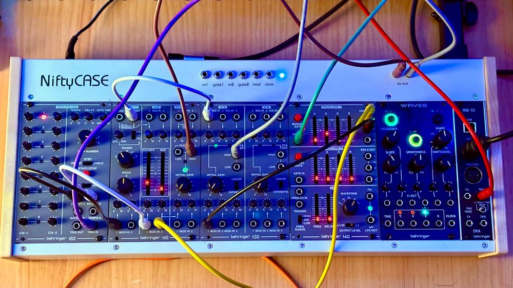 A pic of my small modular synth setup with patch cables connecting a bunch of stuff