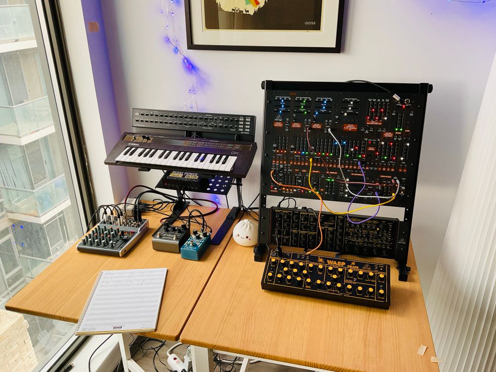 Table full of synthesizers and music gear