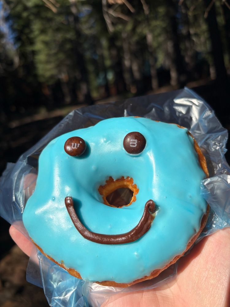 A blue donut with a chocolate smile and m&m’s for eyes :)