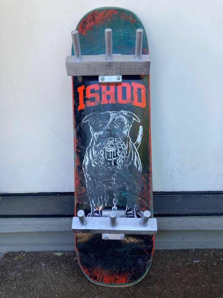 skateboard deck with custom-made hat/coat pegs instead of trucks