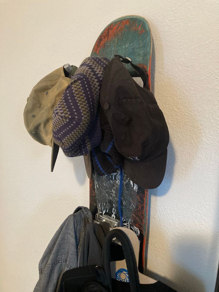skateboard deck with custom-made hat/coat pegs instead of trucks