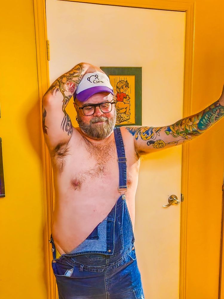 selfie in front of door with overalls