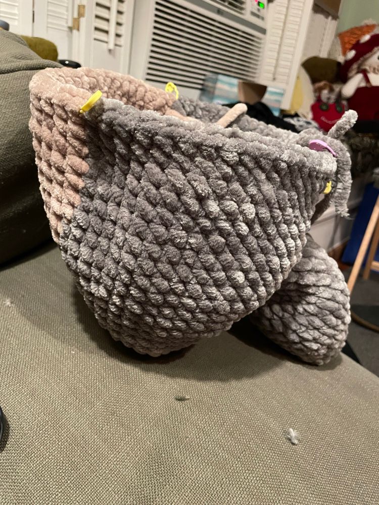 an in process amigurumi totoro, just the waist down. it’s standing up on its own. 
