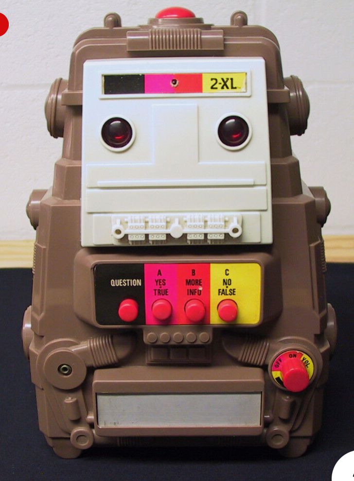 a square robot toy with buttons on the front. it is a 70’s era 2XL and played 8 track tapes